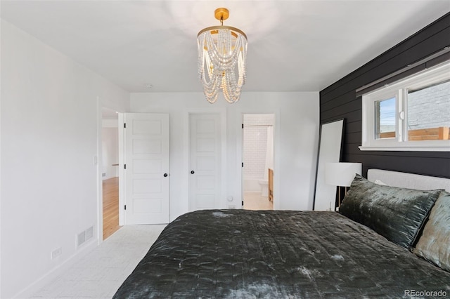 3440 N Harrison St, Denver, CO 80205 - bedroom featuring a chandelier and connected bathroom