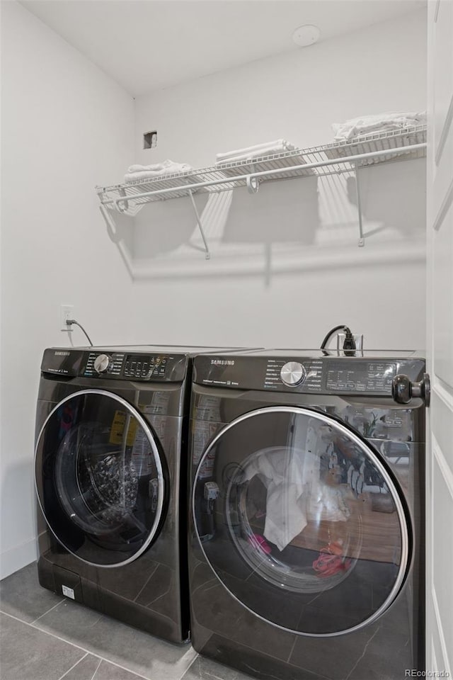 3440 N Harrison St, Denver, CO 80205 - laundry area with washing machine and dryer and tile patterned flooring