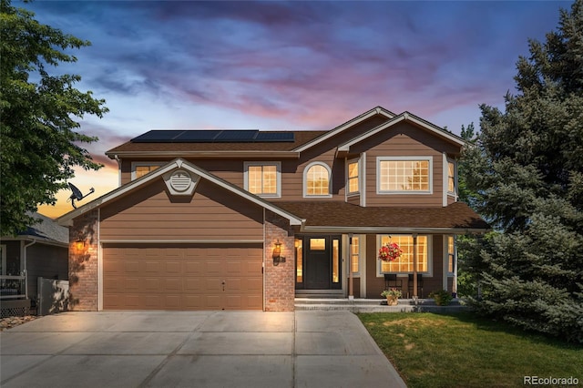 6858 Otis Ct, Arvada, CO 80003 - traditional-style house featuring covered porch, driveway, solar panels, roof with shingles, and a lawn