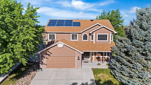 6858 Otis Ct, Arvada, CO 80003 - traditional home with driveway, roof mounted solar panels, roof with shingles, brick siding, and a porch