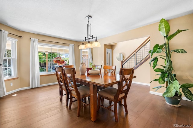 6858 Otis Ct, Arvada, CO 80003 - dining space featuring hardwood / wood-style floors and stairs