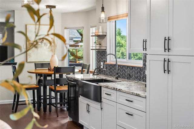 6858 Otis Ct, Arvada, CO 80003 - kitchen featuring healthy amount of natural light, backsplash, white cabinets, and light stone counters