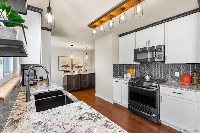 6858 Otis Ct, Arvada, CO 80003 - kitchen with stainless steel appliances, dark wood-style flooring, and backsplash