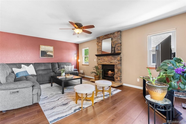 6858 Otis Ct, Arvada, CO 80003 - living area with wood finished floors, a ceiling fan, and a fireplace