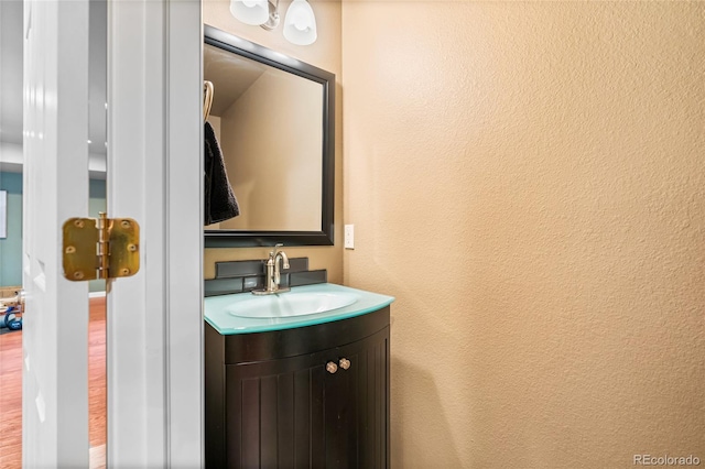 6858 Otis Ct, Arvada, CO 80003 - bathroom with vanity and a textured wall