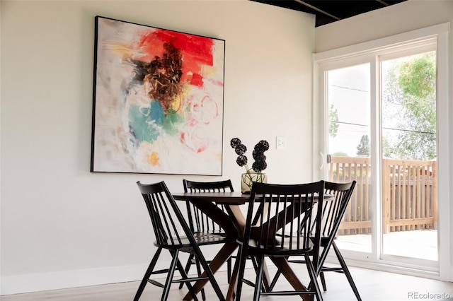 dining area with plenty of natural light and baseboards