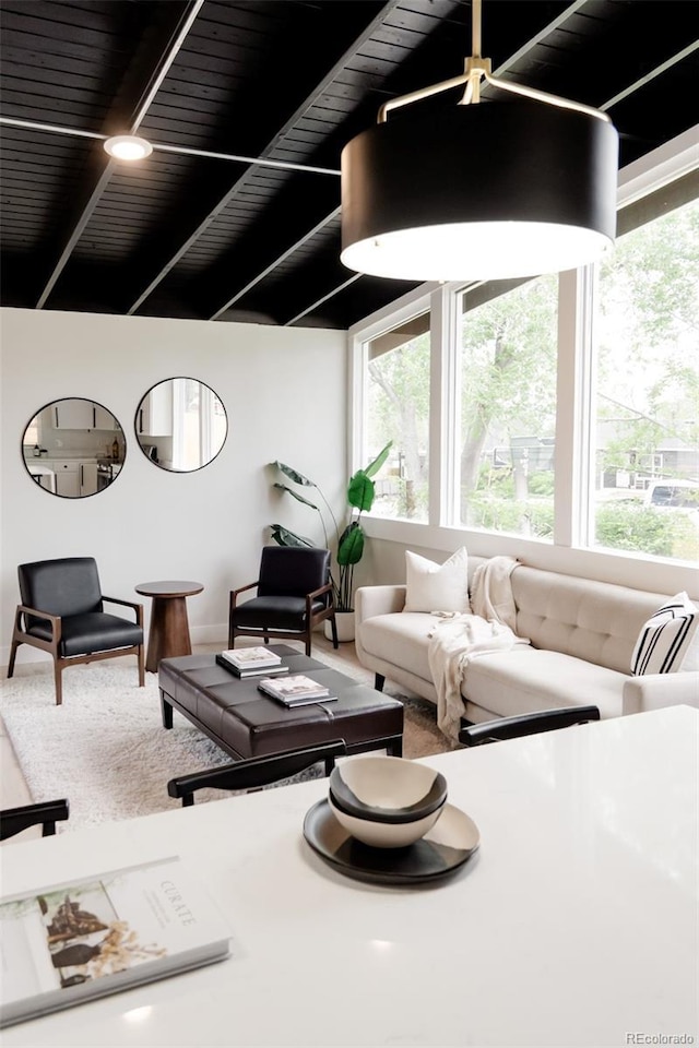living room with plenty of natural light and beam ceiling