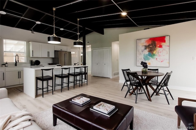 living area featuring light wood-style flooring and baseboards