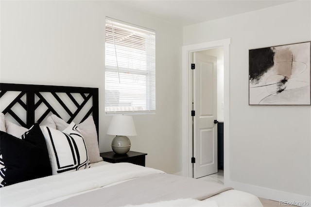 bedroom with multiple windows and baseboards