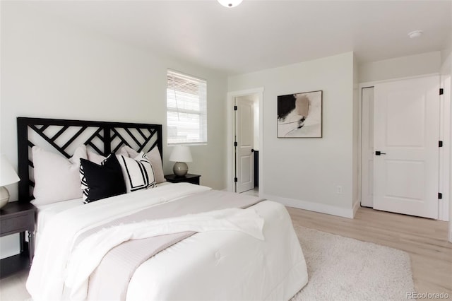 bedroom with wood finished floors and baseboards