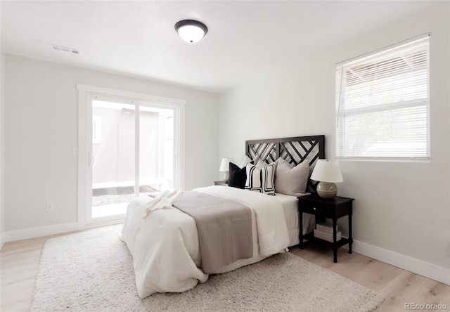 bedroom with wood finished floors and baseboards