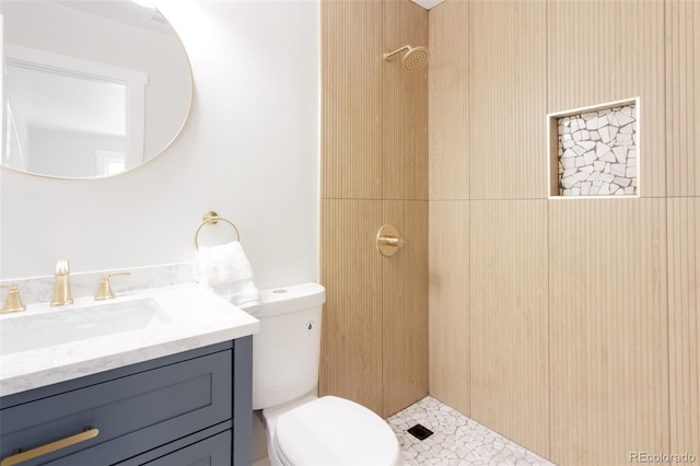 full bathroom featuring toilet, vanity, and a shower