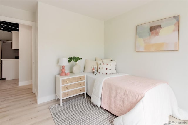 bedroom featuring wood finished floors and baseboards