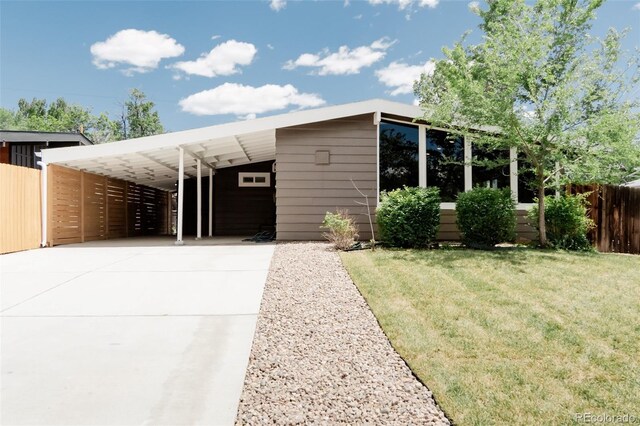 view of front of home featuring concrete driveway and an attached carport