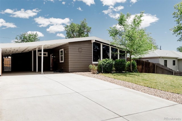 view of front of home featuring driveway and a carport