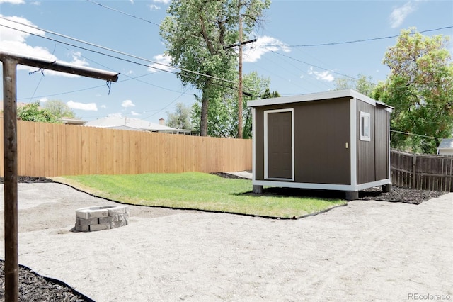view of yard featuring an outdoor structure, a storage unit, and a patio