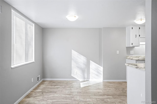 spare room featuring light hardwood / wood-style flooring