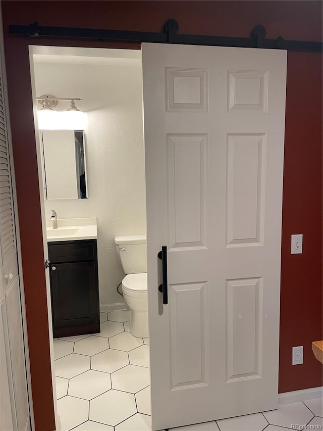 bathroom with tile patterned floors, toilet, and vanity