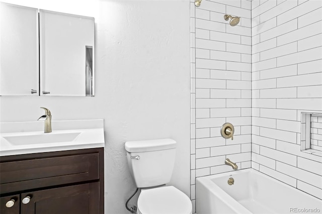 full bathroom with vanity, toilet, and tiled shower / bath