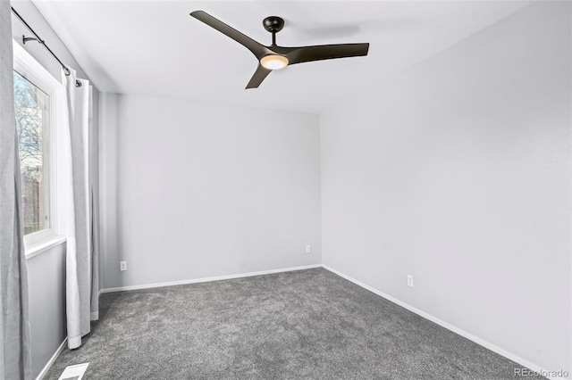 carpeted spare room featuring ceiling fan