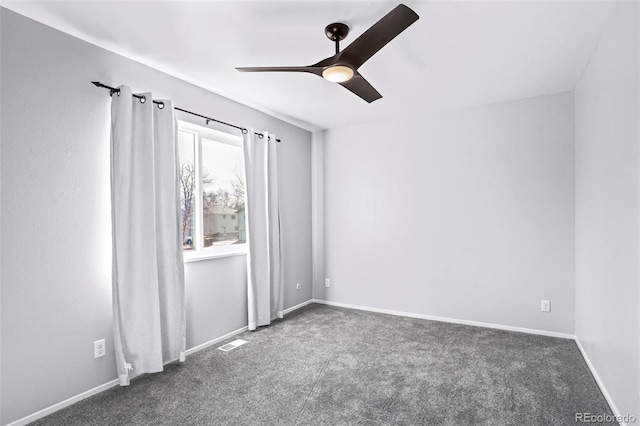 unfurnished room featuring ceiling fan and dark colored carpet