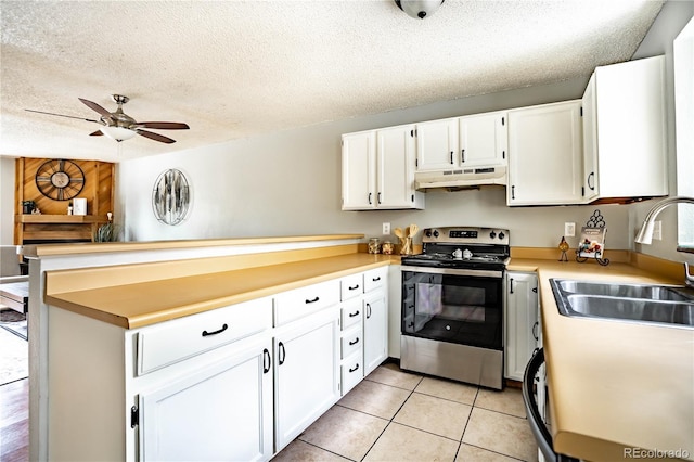 kitchen with stainless steel electric stove, white cabinetry, a textured ceiling, and custom range hood