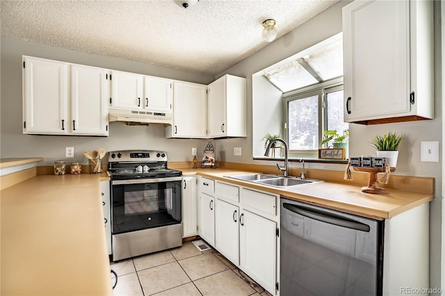 kitchen with a textured ceiling, white cabinetry, sink, and appliances with stainless steel finishes