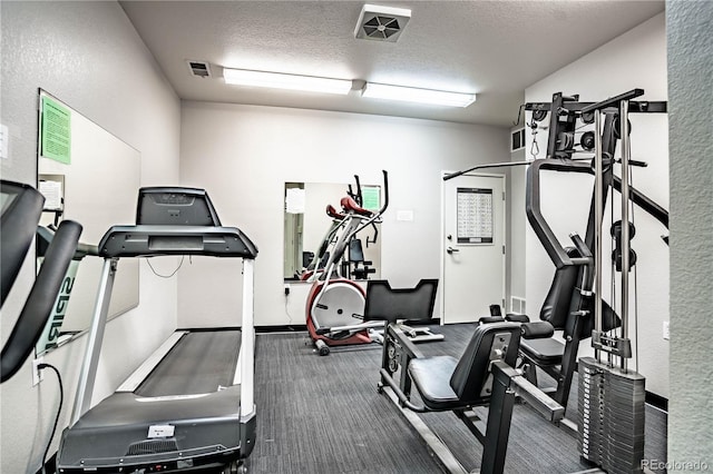 exercise room featuring a textured ceiling