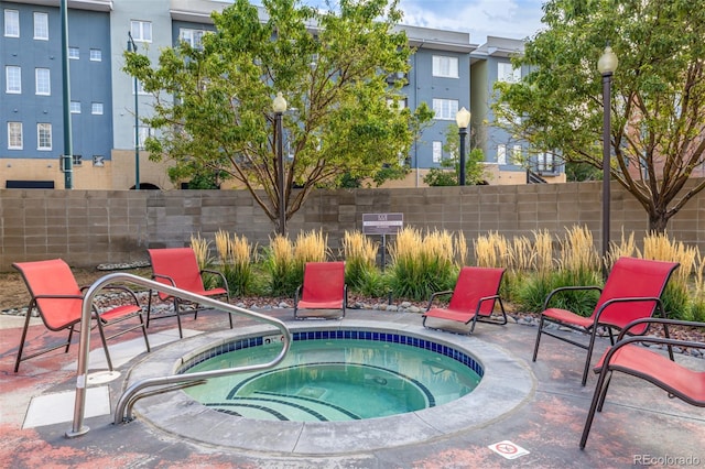 view of swimming pool featuring a patio and a community hot tub