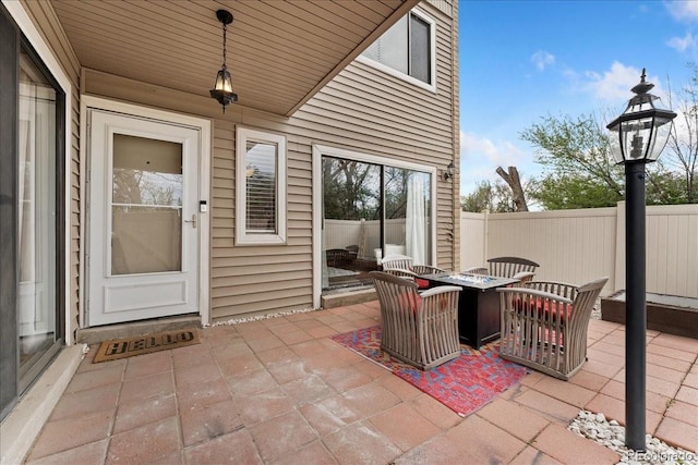 view of patio with a fire pit and fence