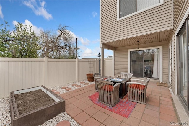 view of patio / terrace featuring a fire pit and a fenced backyard