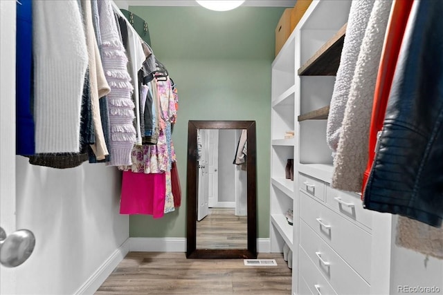 spacious closet featuring light wood-type flooring and visible vents