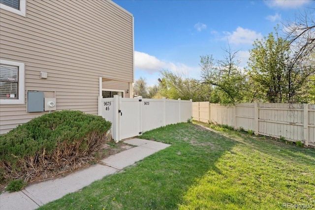 view of yard featuring fence private yard and a gate