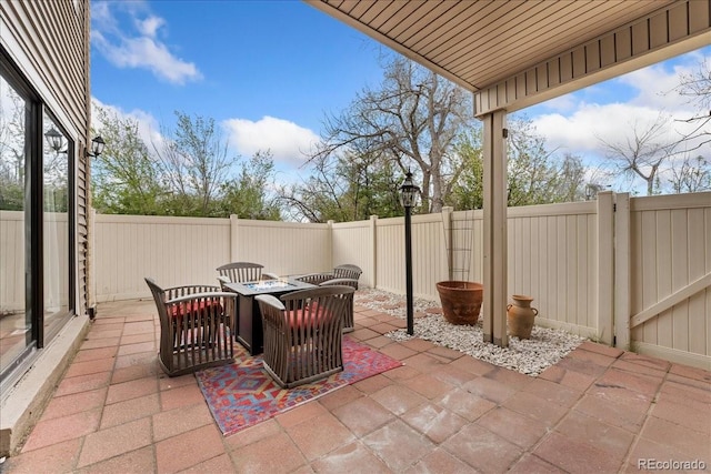 view of patio / terrace with a fenced backyard and a fire pit