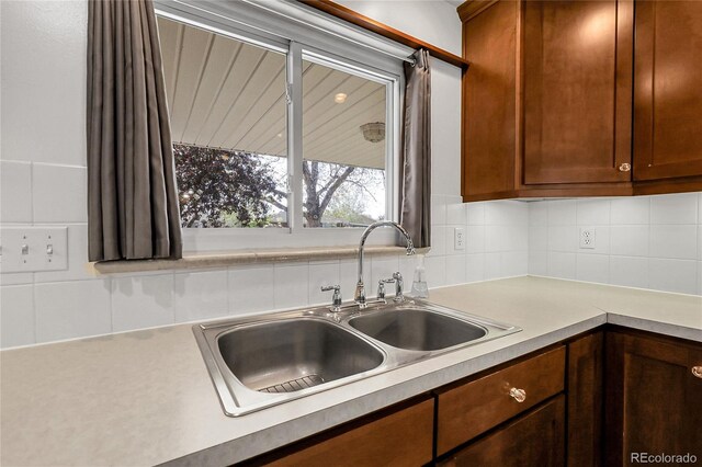 3022 Blackhawk St, Aurora, CO 80011 - kitchen with a sink, backsplash, and light countertops