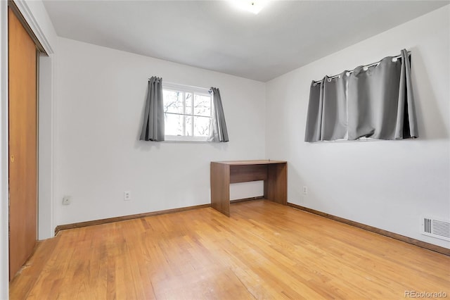 3022 Blackhawk St, Aurora, CO 80011 - unfurnished bedroom featuring baseboards, visible vents, light wood finished floors, and a closet