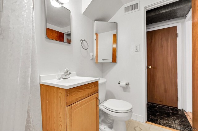 3022 Blackhawk St, Aurora, CO 80011 - bathroom with toilet, baseboards, visible vents, and vanity