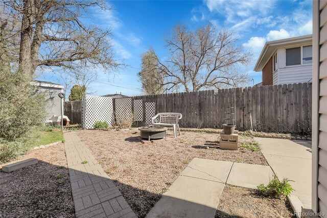 3022 Blackhawk St, Aurora, CO 80011 - view of yard with a fenced backyard and an outdoor fire pit