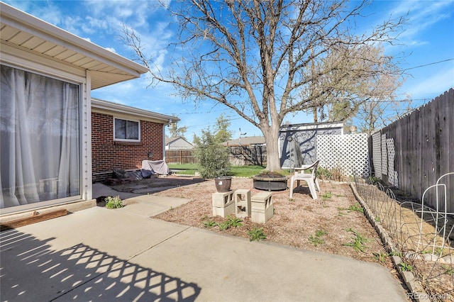 3022 Blackhawk St, Aurora, CO 80011 - view of yard with a fire pit, a fenced backyard, and a patio area