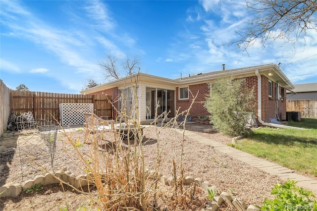 3022 Blackhawk St, Aurora, CO 80011 - rear view of property featuring a patio, cooling unit, fence private yard, and brick siding