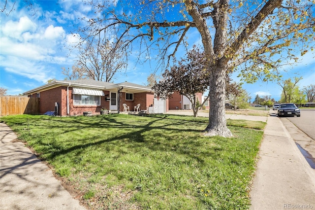 3022 Blackhawk St, Aurora, CO 80011 - ranch-style home with brick siding, fence, and a front lawn