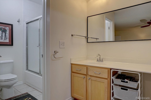 full bathroom featuring bath / shower combo with glass door, vanity, ceiling fan, tile patterned flooring, and toilet