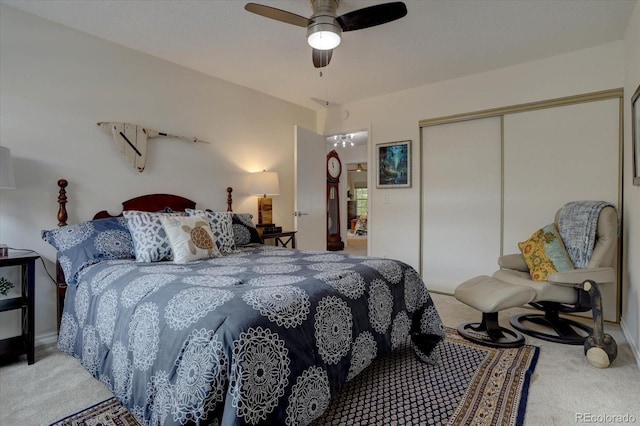 bedroom featuring ceiling fan, light carpet, and a closet