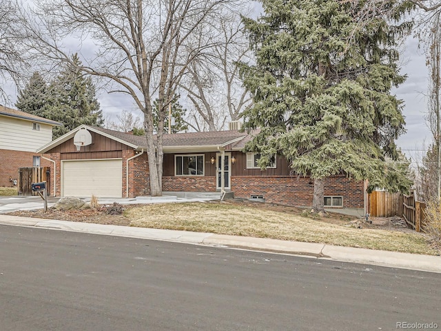 view of front of house featuring a garage and a front lawn