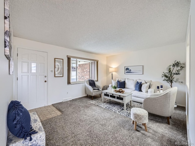 carpeted living room with a textured ceiling