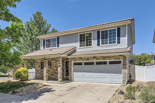 18807 E 51st Pl, Denver, CO 80249 - view of front of home with stone siding, driveway, a tiled roof, and a garage