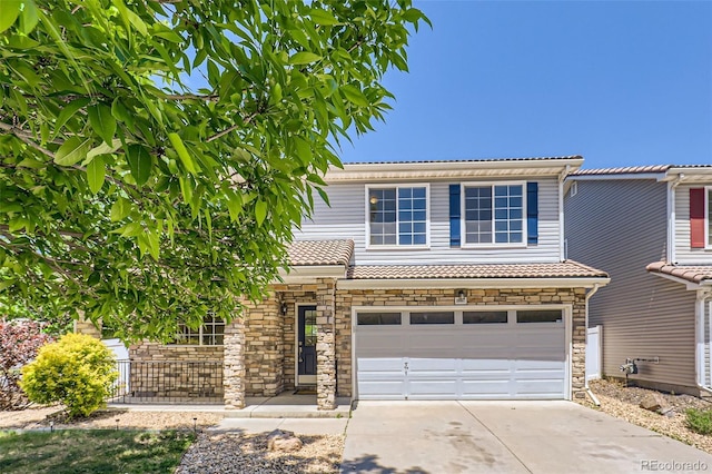 18807 E 51st Pl, Denver, CO 80249 - view of front facade with a garage, driveway, stone siding, and a tile roof