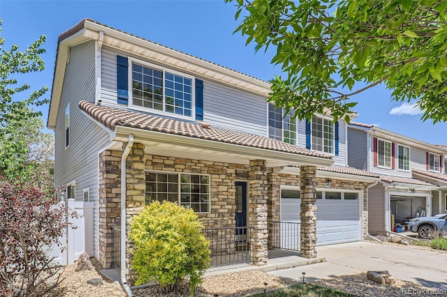 18807 E 51st Pl, Denver, CO 80249 - view of front facade with a garage, driveway, stone siding, and a tile roof