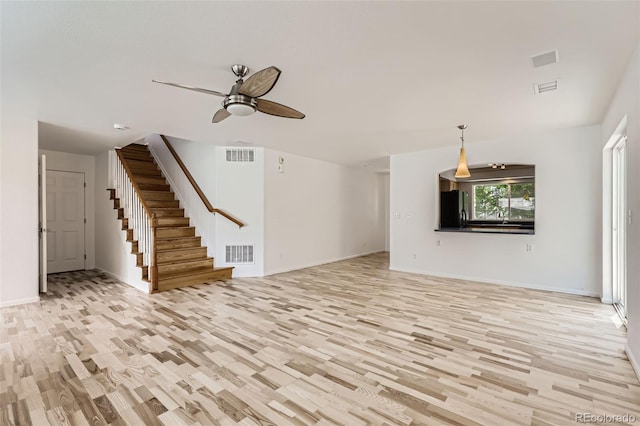 18807 E 51st Pl, Denver, CO 80249 - unfurnished living room featuring light wood-style flooring, ceiling fan, stairway, and baseboards