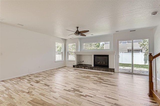 18807 E 51st Pl, Denver, CO 80249 - unfurnished living room with wood finished floors, a ceiling fan, and plenty of natural light